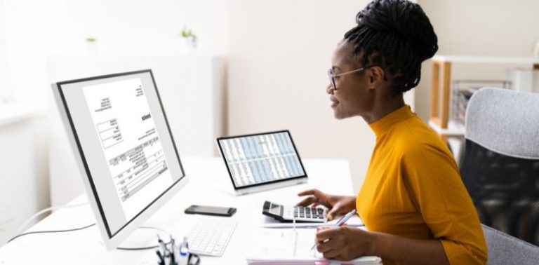 A woman looking at spreadsheets on a computer.