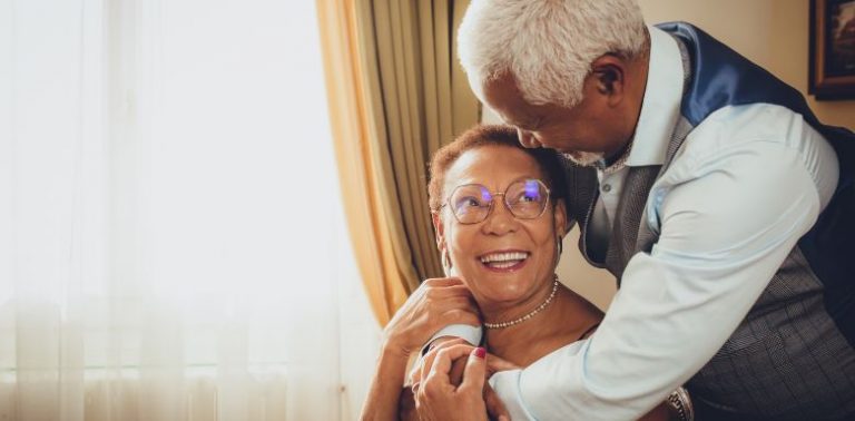 An older couple embracing.