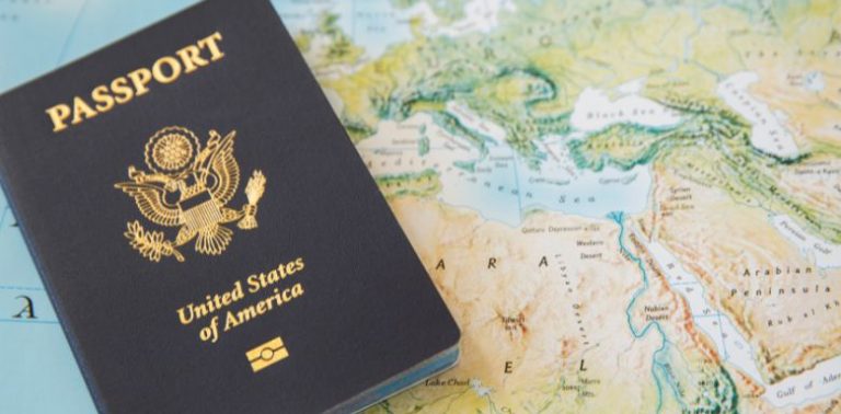 An American passport on top of a world map.