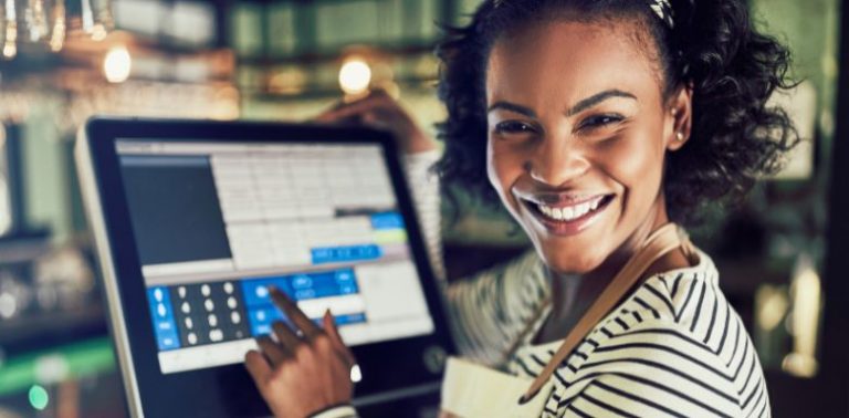 A woman using a POS system at work.