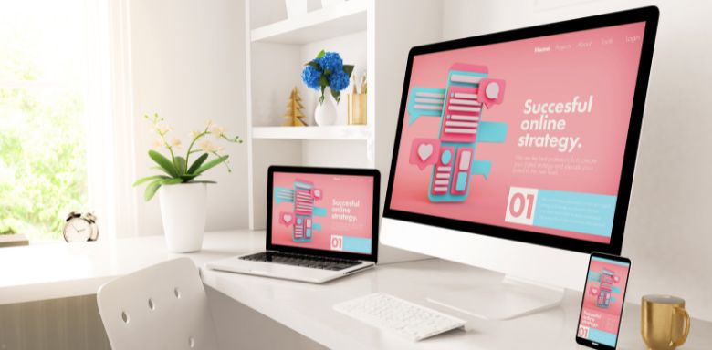 Computer monitors showing a pink screen with digital marketing strategies.