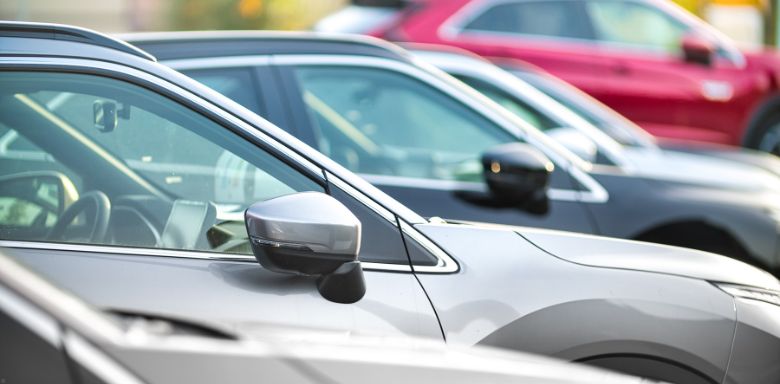 Multiple cars parked in a lot together.