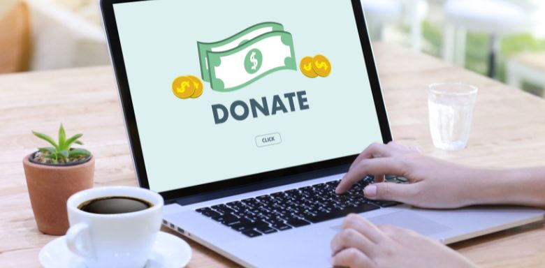 A laptop showing the words "donate"